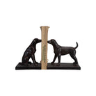 Bronze bookends shaped like dogs holding a ruler on a white background