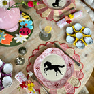 Decorative table setting with horse-themed plates and colorful placemats.