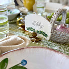 Table setting with a name card labeled 'Libby' on a decorative plate.