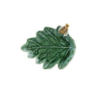 Green leaf-shaped brooch with a gold center on a white background