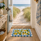 Nautical-themed interior with a lemon-patterned rug, beach view, and coastal decor.