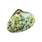 A vintage-style oyster shell brooch featuring a hand-painted lemon and olive branch pattern on a pale blue background, with a gold-toned metal border and hinge.
