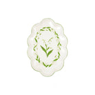 An oval ceramic serving platter with scalloped edges, featuring a green lily of the valley floral design on a white background.