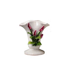 White ceramic vase with floral design on a white background