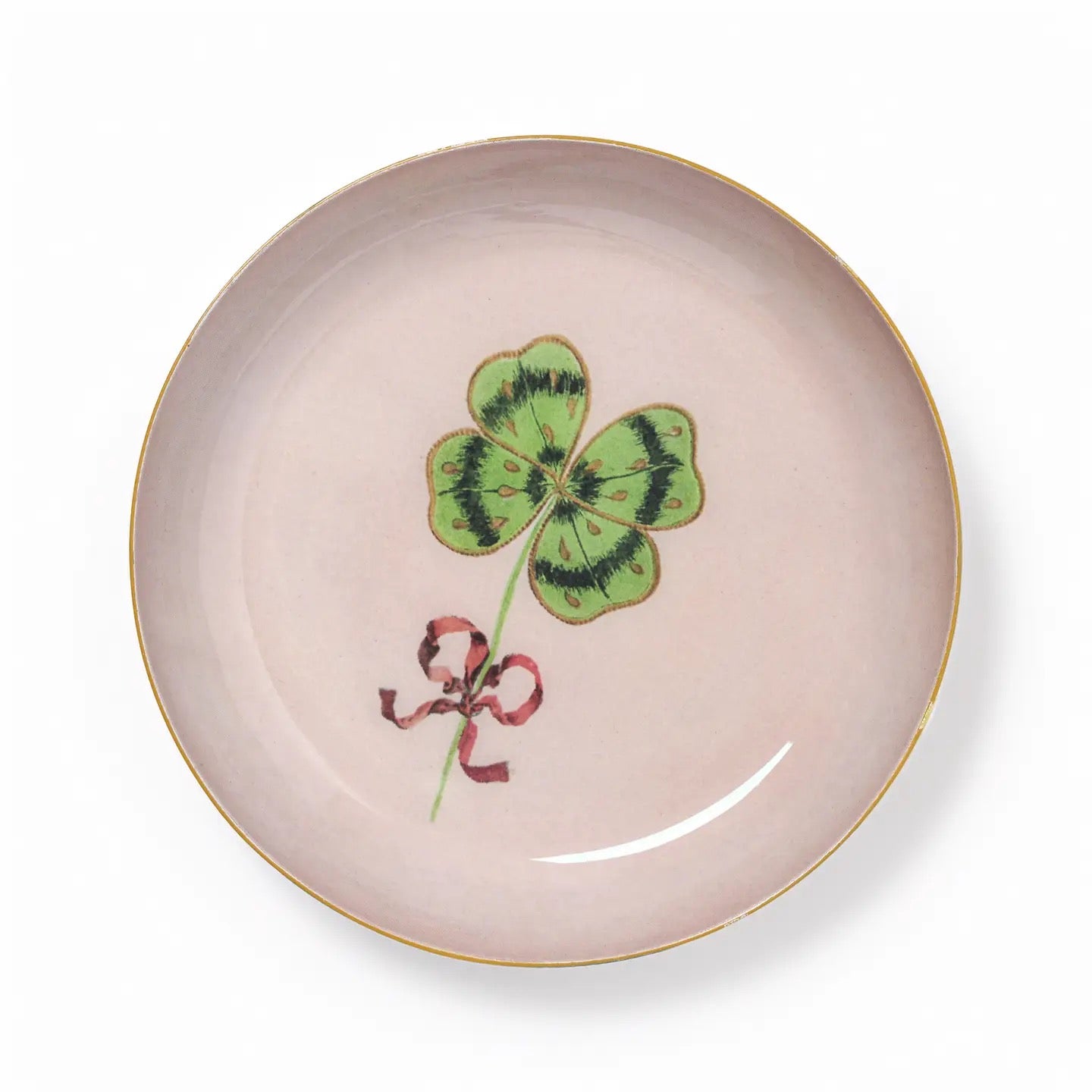 Ceramic plate with a four-leaf clover design on a light pink background