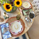 Decorative table setting with sunflowers, ceramic plates, and a horse-themed placemat.