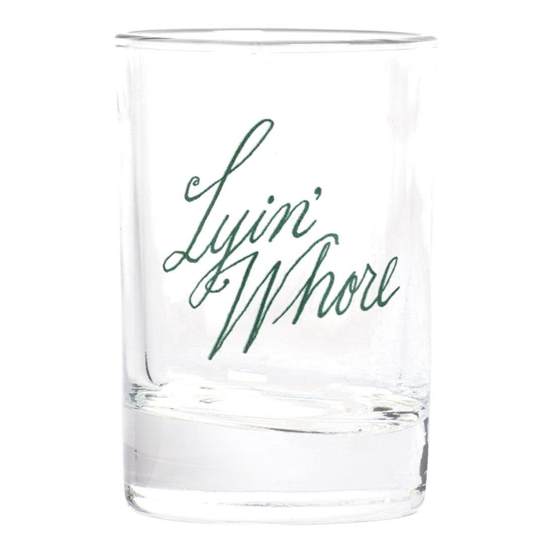 A clear glass rocks tumbler with the phrase 'Lyin' Whore' printed in dark green cursive script on the front, set against a plain white background.