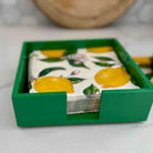 Green tray with a lemon-themed napkin on a light surface