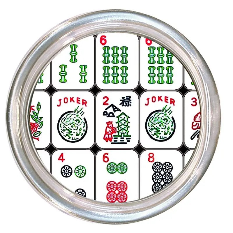 Circular object with Mahjong tile designs on a white background