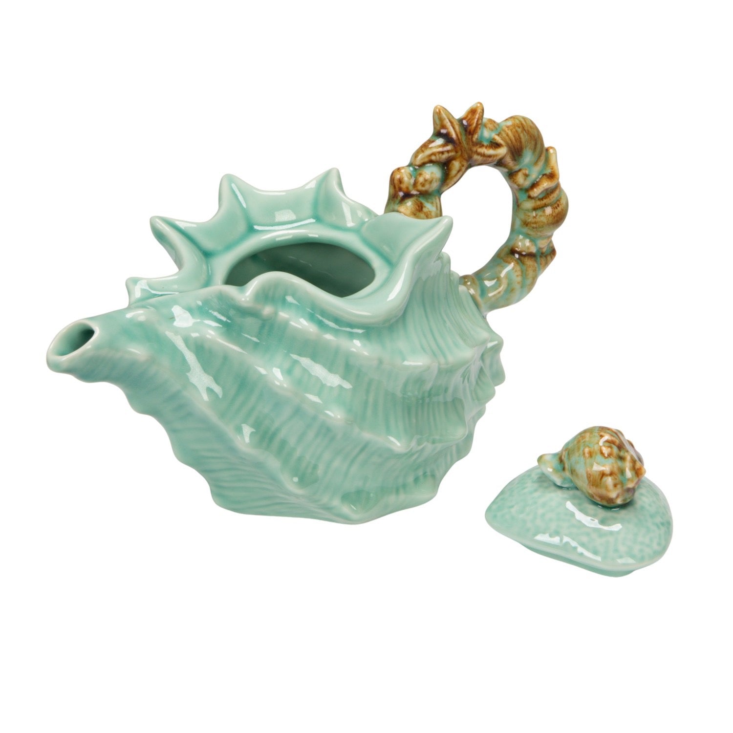 Ceramic shell-shaped teapot with a smaller shell on a white background