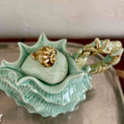Decorative ceramic shell with a gold shell on a neutral background