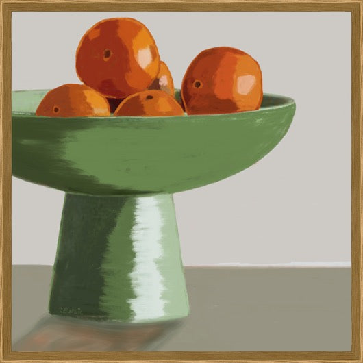A framed still life painting depicting a green pedestal bowl filled with orange persimmon fruits, set against a neutral gray background with a light wood frame.