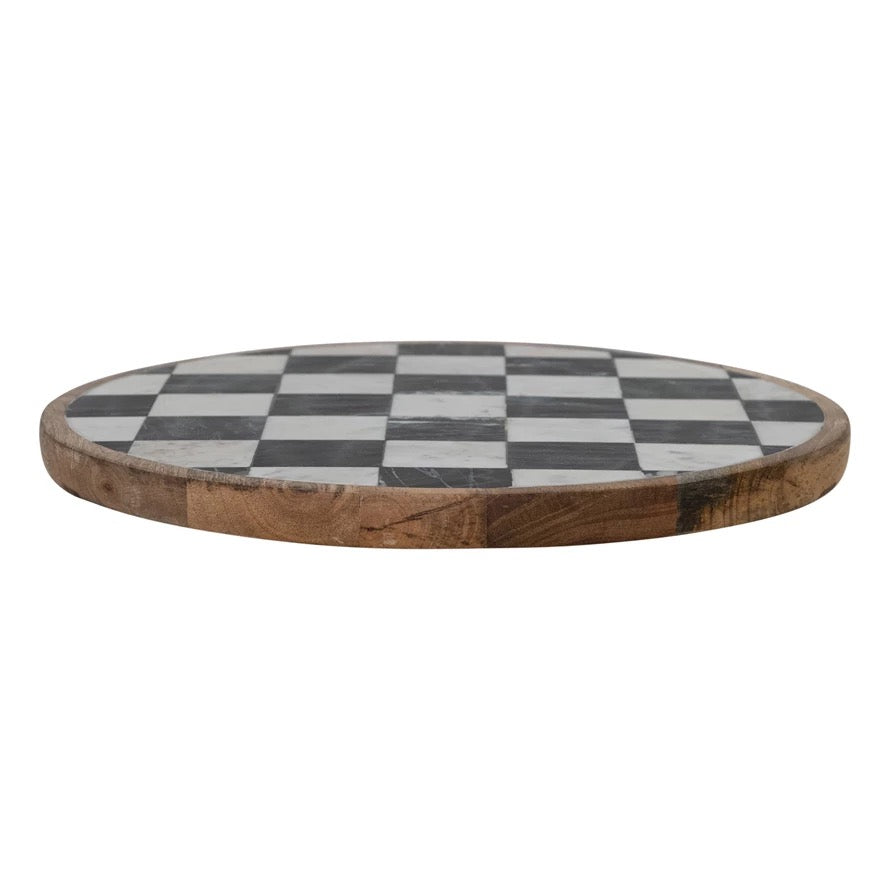 Round wooden board with a checkered pattern on a white background