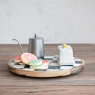 Tea set with cookies on a checkered tray on a wooden surface