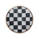 Round table top with black and white checkered pattern on a white background