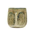 Ceramic cup with textured surface on a white background