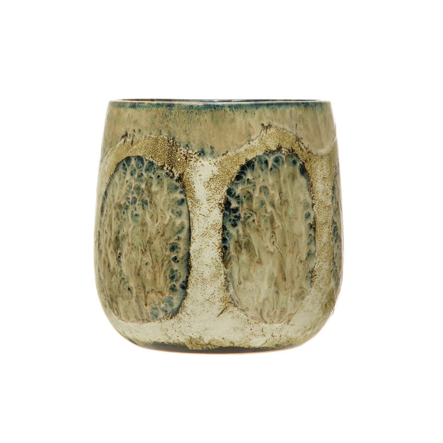 Ceramic cup with textured surface on a white background