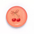 Ceramic plate with cherry design on a white background