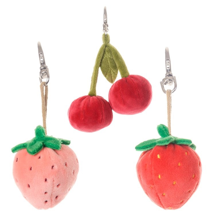 Plush strawberry and cherry earrings on a white background