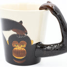 Mug with monkey design and brown handle on a white background