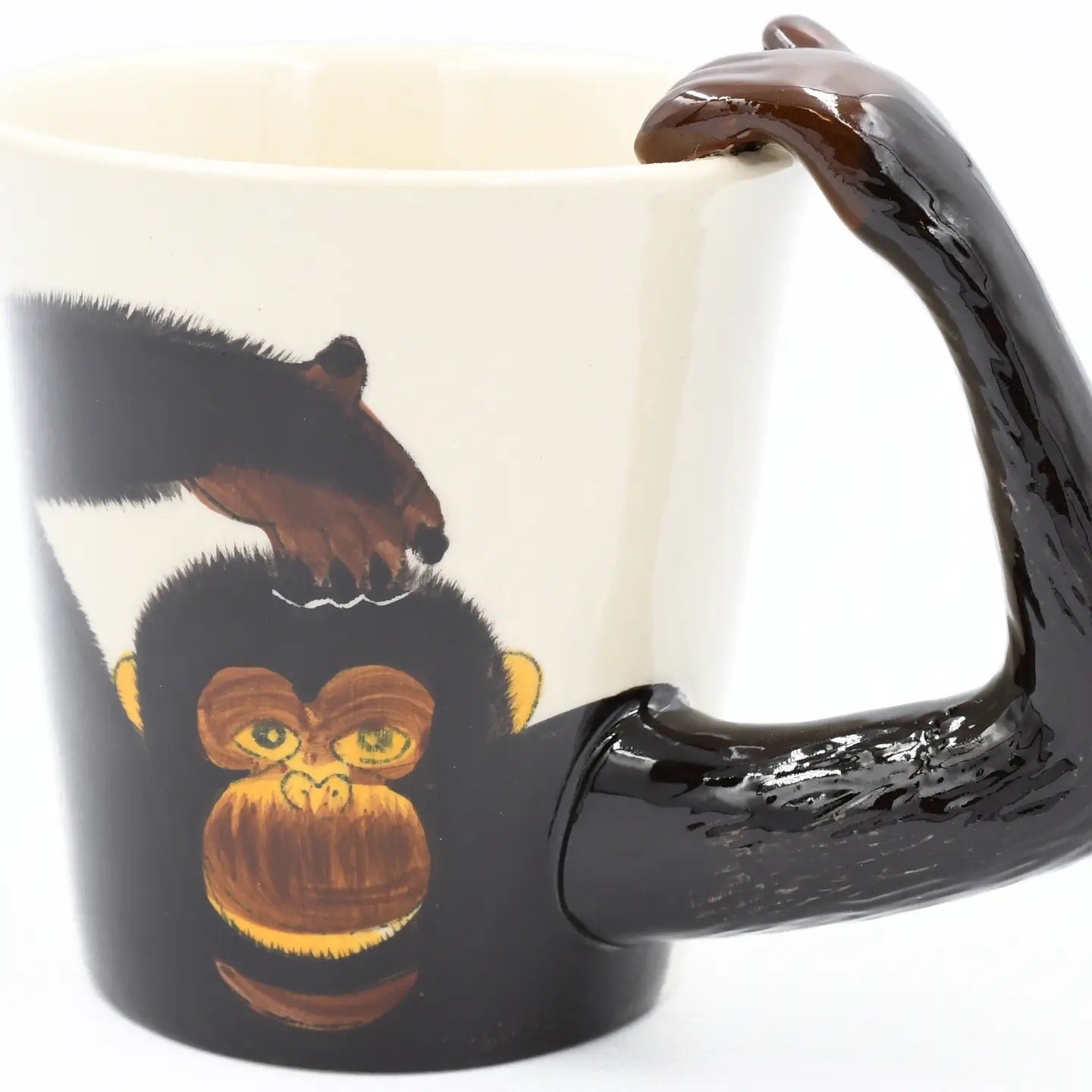 Mug with monkey design and brown handle on a white background