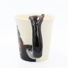 Mug with a black liquid flowing out on a white background