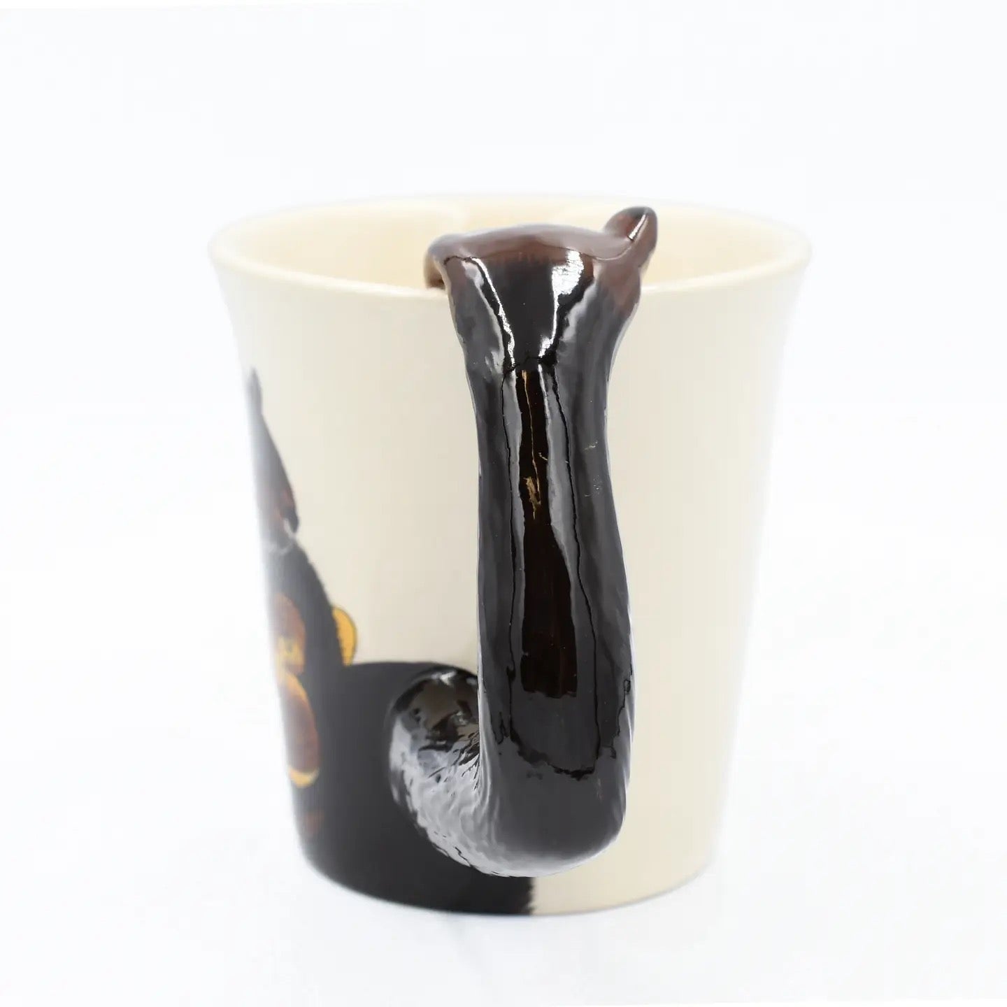 Mug with a black liquid flowing out on a white background