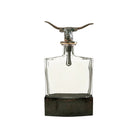 Decorative glass bottle with metal longhorn design on a white background