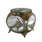Decorative glass container with gold metalwork on a white background