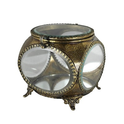 Decorative glass container with gold metalwork on a white background