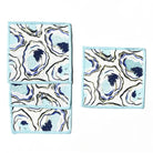 Set of three cloths with a blue and white abstract pattern on a white background