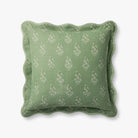 Green pillow with decorative pattern on a white background