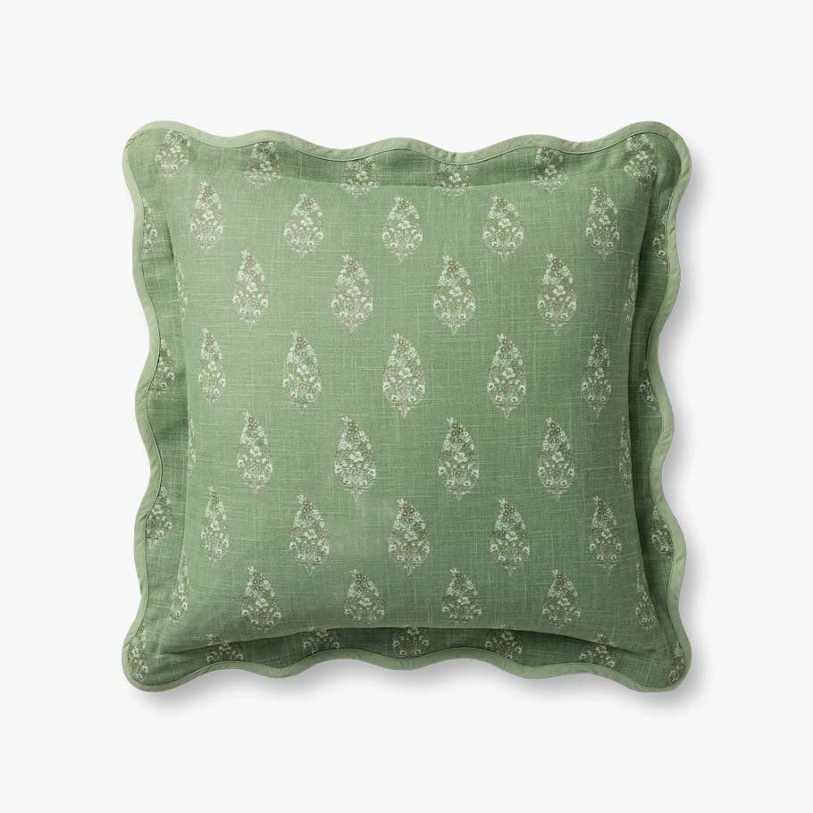 Green pillow with decorative pattern on a white background