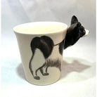 Ceramic mug with a black and white cat design on a white background