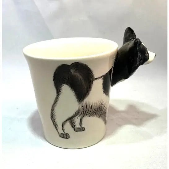 Ceramic mug with a black and white cat design on a white background