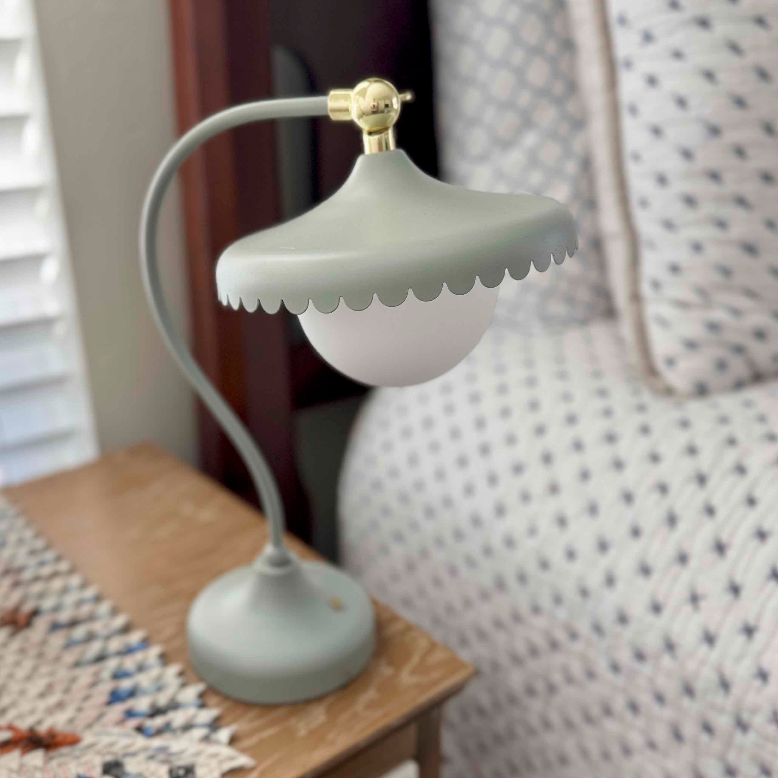 Small lamp with a scalloped design on a wooden surface