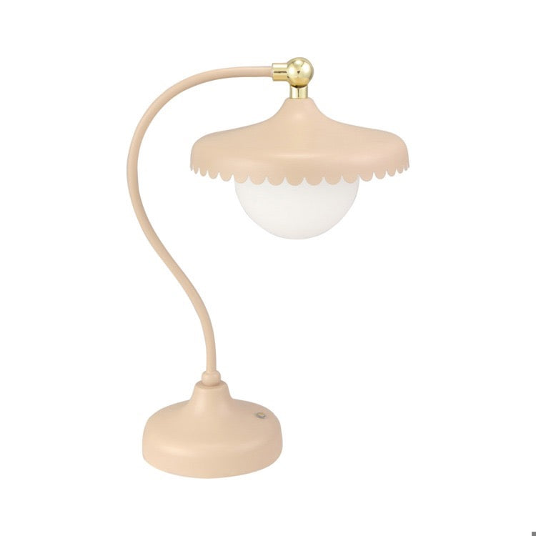 Beige table lamp with a white bulb on a white background