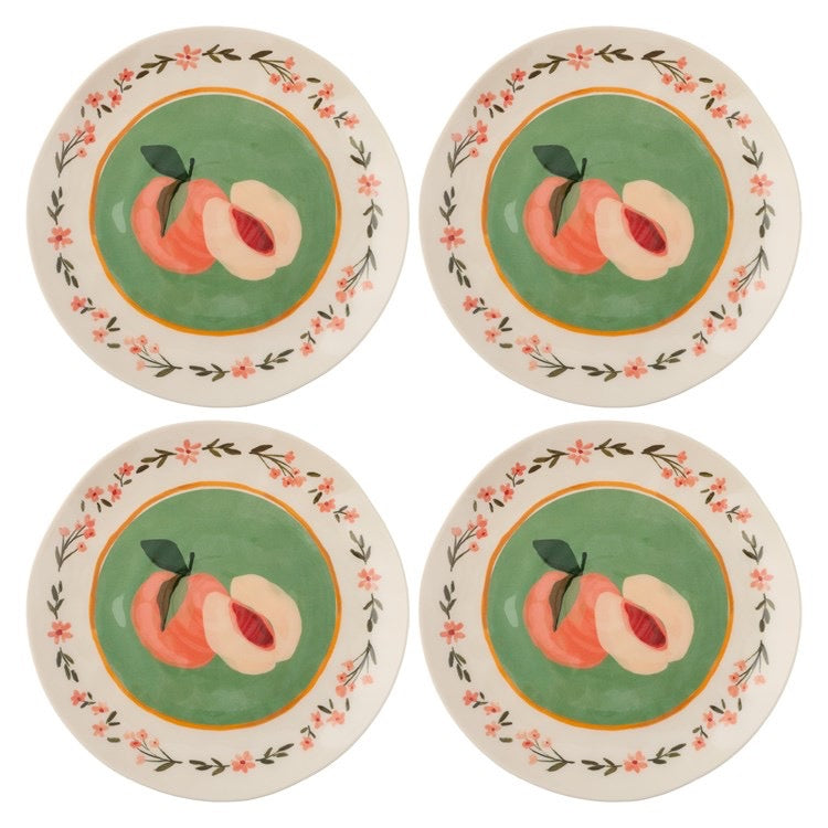 Four ceramic plates with peach illustrations on a white background