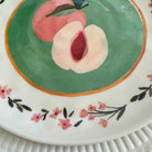 Decorative plate with painted peaches and floral design