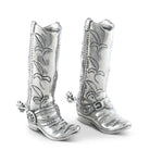A pair of pewter salt and pepper shakers designed to look like cowboy boots, featuring detailed embossing and spurs.
