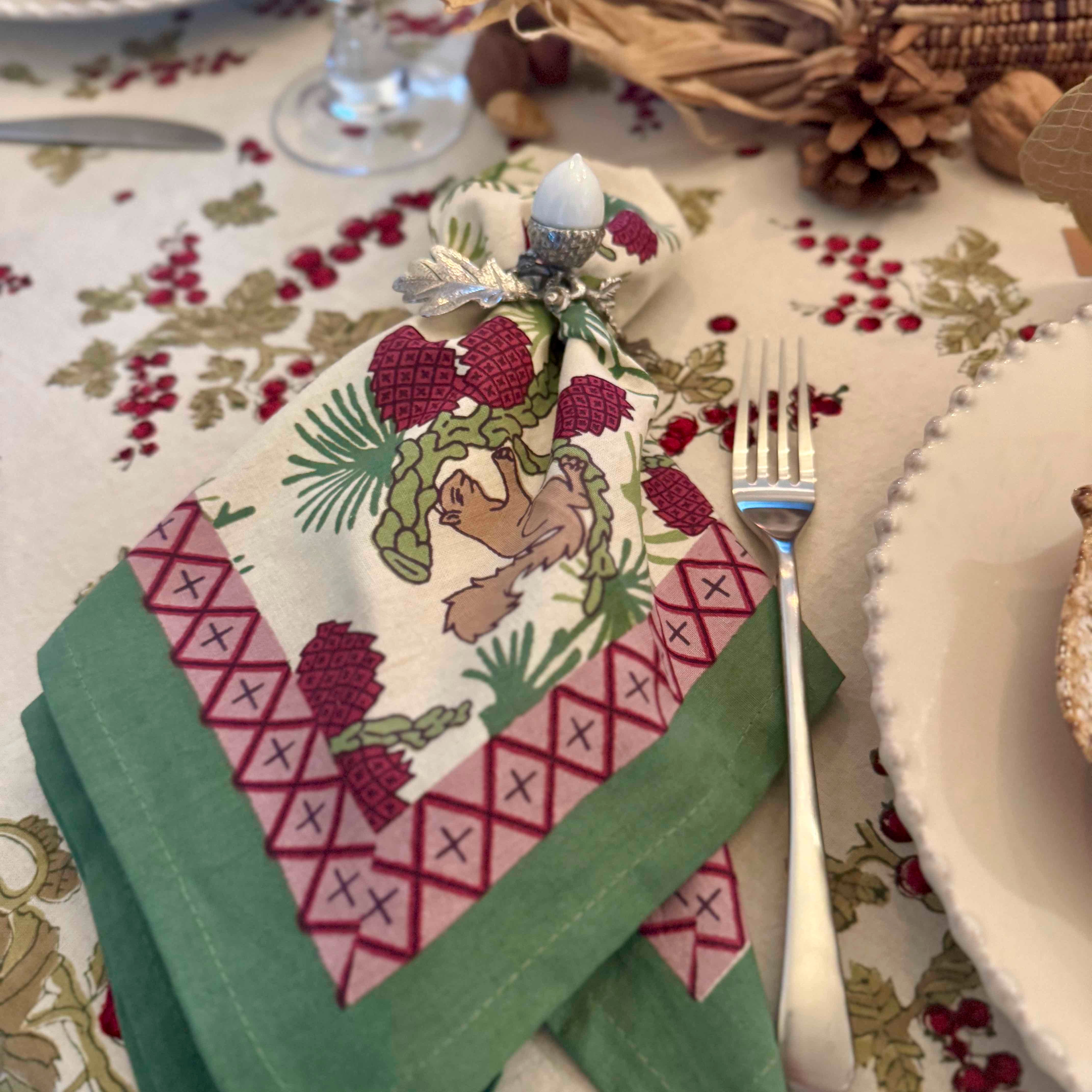 Decorative folded napkin with a bird design on a festive table setting.