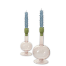 Two candle holders with blue candles and green candle wicks on a white background