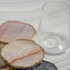 Set of decorative coasters with a glass on a light background