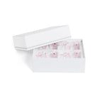 White jewelry box with pink floral designs on a white background