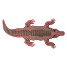 Red alligator-shaped object on a white background