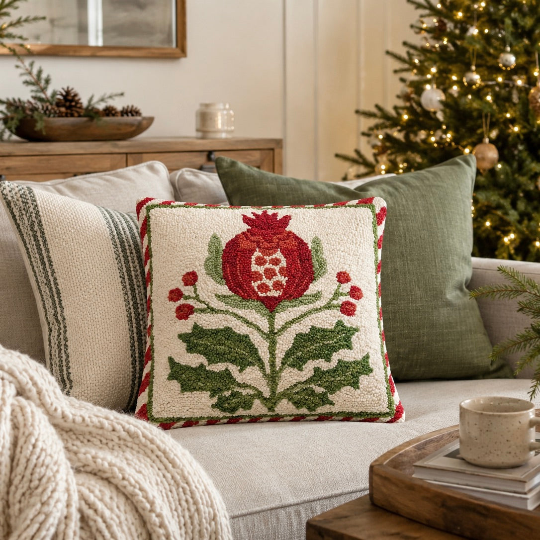 Decorative pillow with floral pattern on a couch in a living room with a Christmas tree.
