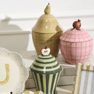 Decorative ceramic jars with lids on a white surface