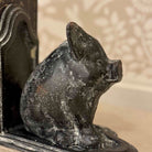 Decorative black pig sculpture on a textured surface