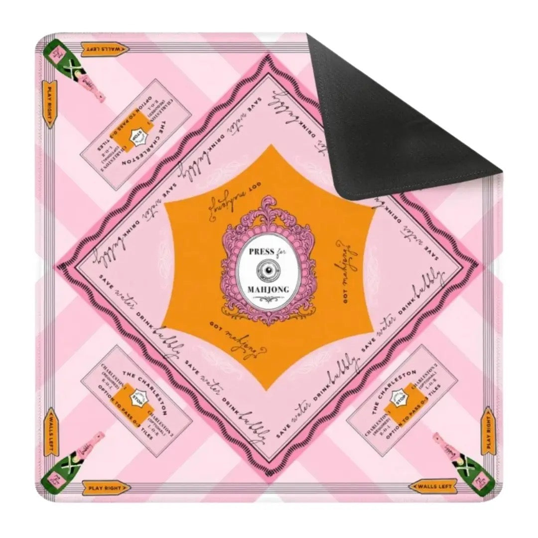Pink and orange board game box with decorative elements on a white background