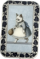 Decorative tin with a cat in a dress holding a basket, surrounded by floral patterns.